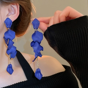Detail of elegant blue multi-layer rose petal tassel earrings on model showing long drop style