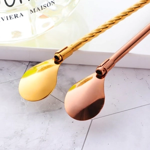 Gold and rose gold 304 stainless steel straw spoons with a spiral handle on a white tray
