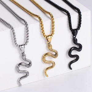 Detailed view of cobra snake pendants in silver, gold, and black finishes on chains