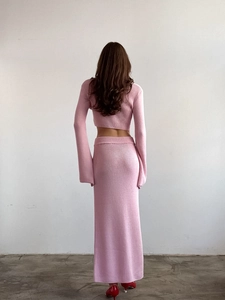 Vue de dos de l'ensemble en tricot côtelé rose avec haut court et jupe longue ajustée