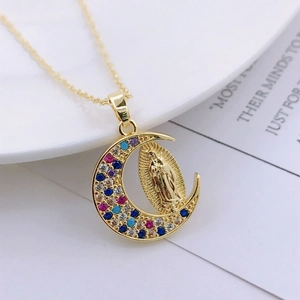 Detail of gold crescent moon pendant with multi-color zircon inlay and Virgin Mary relief