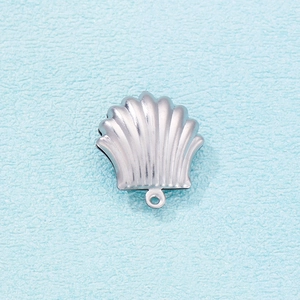 Macro shot of silver shell pendant with detailed texture and small bottom ring