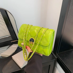 Quilted green cross-body bag with gold chain strap and metal lock closure for women