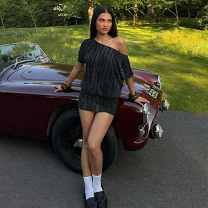 Fashionable black tie-dye one-shoulder mini dress with sexy cutout back on a model