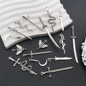 Detailed view of silver zinc alloy sword and dagger charms for DIY jewelry making