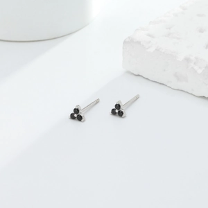 Detailed view of minimalist S925 sterling silver studs with three black zircon stones
