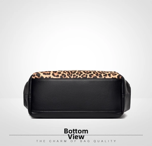 Detail view of the flat pebbled leather bottom and leopard print sides of the handbag