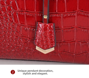 Detailansicht der roten Tasche mit Krokodilprägung und goldenem V-Metallanhänger-Dekor