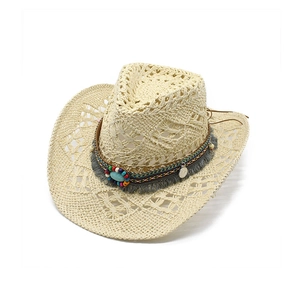 Detailed macro view of Western straw hat with turquoise beads and bohemian fringe tassel