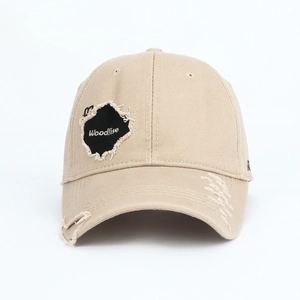 Detailed close-up of distressed khaki cotton baseball cap with embroidered logo patch
