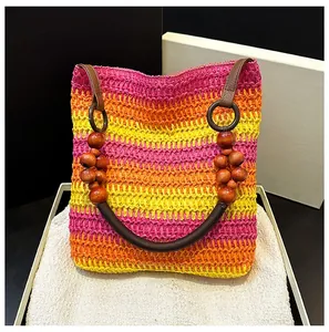 Detail of bohemian rainbow crochet tote with wooden beads and premium leather handles