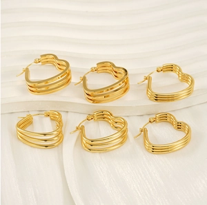Detail view of triple-layered golden heart-shaped hoop earrings with a sleek metallic finish