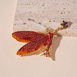 Vintage fairy wings brooch with red enamel and a colorful star crystal pendant