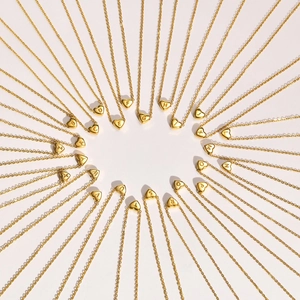 Golden heart initial necklace collection featuring A-Z alphabet pendants on thin chains