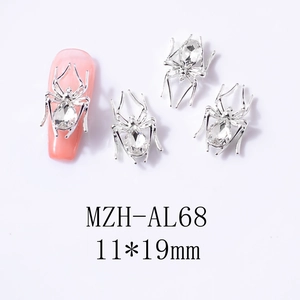 Detailed view of silver spider nail charms with 11x19mm teardrop crystal rhinestones