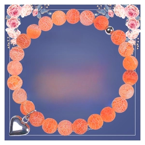 Detail of orange dragon vein agate bracelet with heart charm on a healing message card