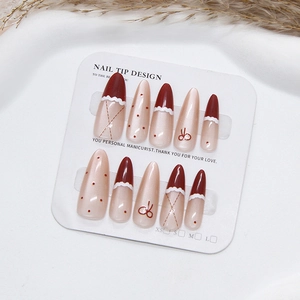 Handmade burgundy and cream almond press-on nails with bow and polka dot patterns