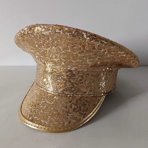 Macro shot of gold sequin military cap for parties showing rear texture and shape
