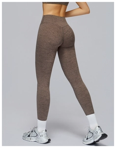 Close-up of high-waisted heathered yoga pants showing compression fabric and lift effect