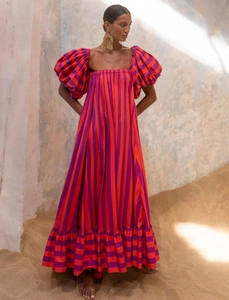 Detail view of puff sleeves and orange striped fabric on a summer maxi beach dress