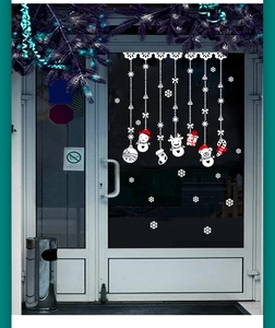 Window decals featuring white snowman, reindeer, and candy cane Christmas decorations