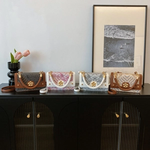 Four elegant small square crossbody bags with embossed patterns and gold floral buckles