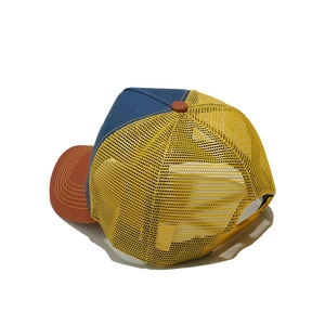 Detail view of the breathable mesh back and adjustable strap on the color-block truck cap