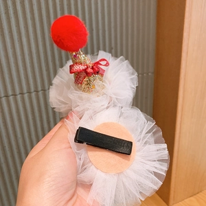 Detail view of children's Christmas hair clips with gold glitter hat and metal duckbill clip