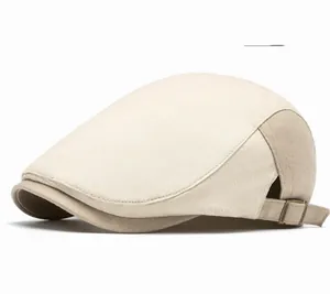 Detail of beige newsboy hat with adjustable bronze metal buckle and twill cotton texture
