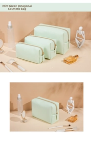 Detailed view of light green octagonal makeup bags with gold zippers and textured PU leather