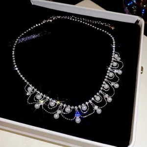 Elegant pearl and rhinestone tassel necklace displayed in a luxury black velvet jewelry box