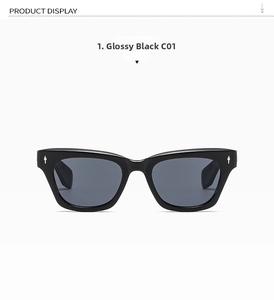 Detail of bright black cat-eye sunglasses with signature silver metal rivets on the side