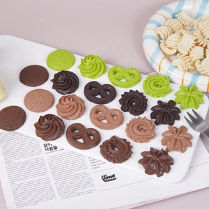 Realistic artificial colorful cookies in various shapes on a white plate for photography
