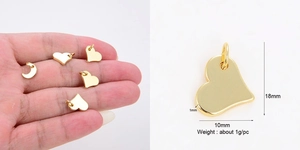 Macro view of gold-plated copper heart and moon pendants with exact size measurements
