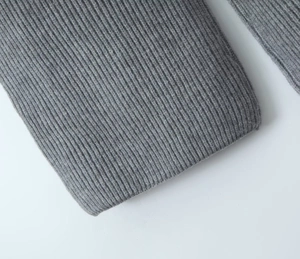 Detailed macro view of the grey ribbed knit fabric texture on the wide-collar lounge set