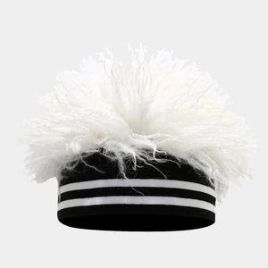 Close-up of fluffy white faux fur texture on black knitted headband with white stripes