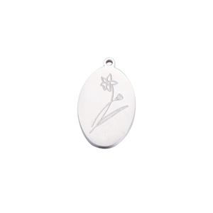 Macro view of mirror-polished stainless steel oval pendant with December birthday flower