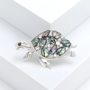 Elegant silver turtle brooch with colorful abalone shell inlay and crystal accents