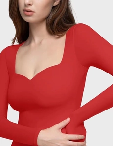 Detail of red long sleeve crop top with sweetheart neckline and smooth elastic fabric