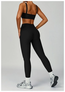 Rear view detail of ribbed black high-waisted yoga leggings and open-back sports bra set