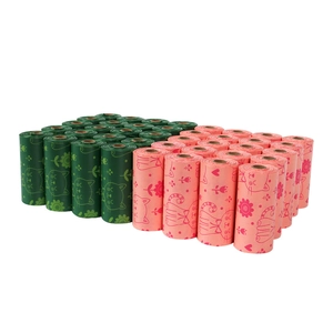 Biodegradable corn starch pet waste bags in green and pink with cute cat floral patterns
