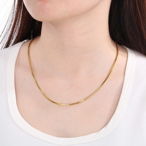 18K gold plated stainless steel snake bone chain necklace shown on a model neck