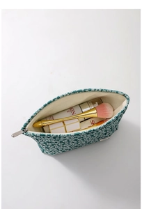 Detail view of large green floral canvas cosmetic bag with zipper and inner lining