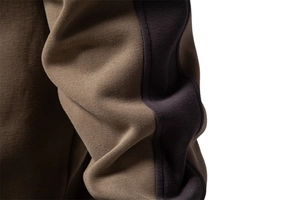 Detail of high-density knit fabric texture and stitching on patchwork sports sweatshirt