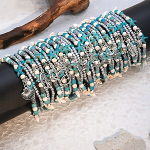 Detail of layered bohemian anklet set with turquoise beads and sea turtle charms