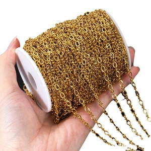 Gold stainless steel embossed oval link chain for DIY jewelry making on a white spool