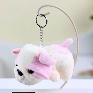 Detail shot of a plush bulldog keychain accessory with soft texture and metal ring