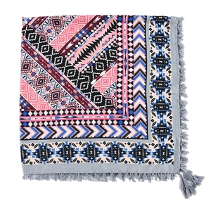 Detailed view of bohemian square scarf with geometric patterns and knotted fringes