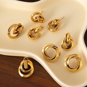 Elegant gold titanium steel geometric C-shaped earrings set on a minimalist tray