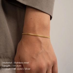 Detail of adjustable 14K gold plated Cuban link bracelet on a woman wrist